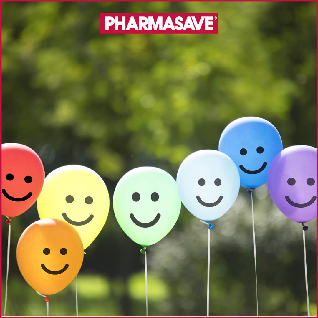party balloons with smily faces on them floating outdoors
